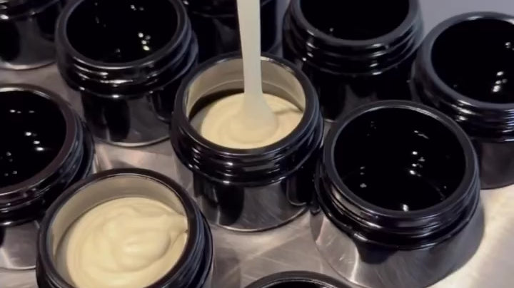 Load video: Pouring Kakadu Plum Moisturiser into glass jars.